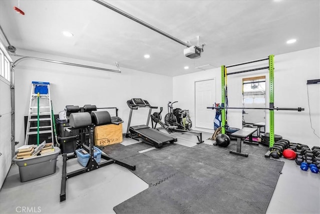 gym featuring a wealth of natural light, recessed lighting, and a garage