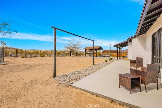 view of patio with a gazebo and fence