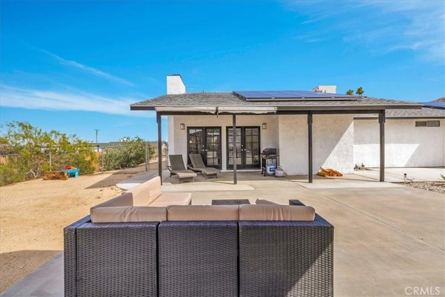 7068 Eucalyptus Ave Unit 29, Palms, CA 92277 - rear view of house with french doors, stucco siding, an outdoor living space, solar panels, and a patio