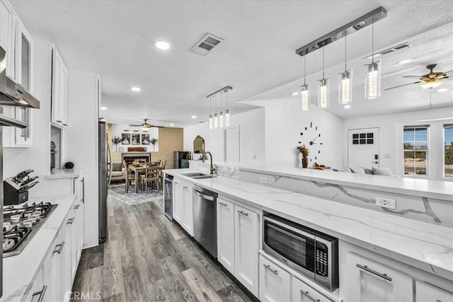 7068 Eucalyptus Ave Unit 29, Palms, CA 92277 - kitchen featuring ceiling fan, appliances with stainless steel finishes, a sink, open floor plan, and recessed lighting