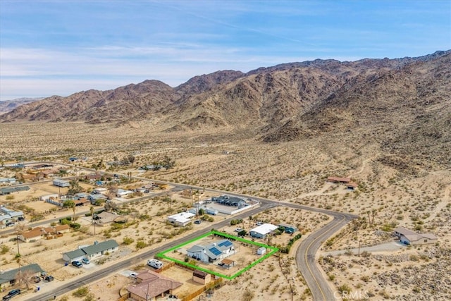 7068 Eucalyptus Ave Unit 29, Palms, CA 92277 - aerial view of sparsely populated area featuring a desert landscape, a mountain backdrop, and property boundaries highlighted
