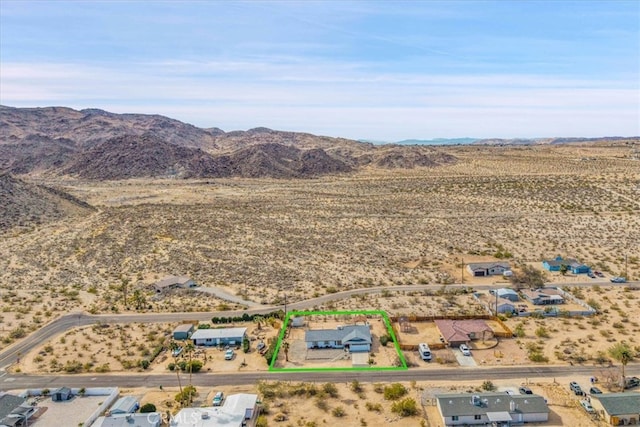 7068 Eucalyptus Ave Unit 29, Palms, CA 92277 - aerial view of sparsely populated area with mountains, property parcel outlined, and a desert landscape