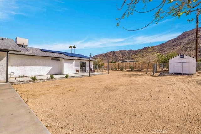 7068 Eucalyptus Ave Unit 29, Palms, CA 92277 - fenced backyard with a patio area, a mountain view, and a shed