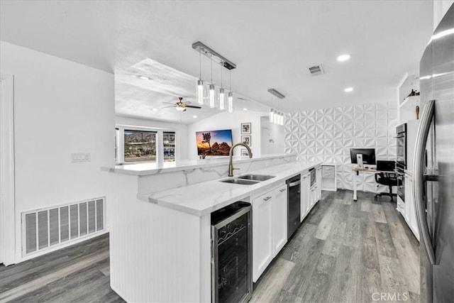 kitchen featuring white cabinetry, wine cooler, visible vents, and a sink