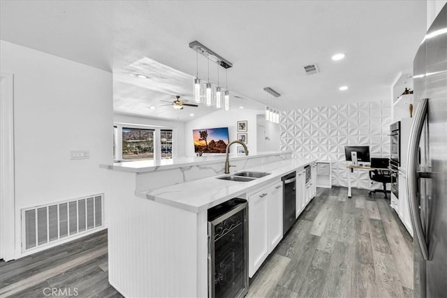 7068 Eucalyptus Ave Unit 29, Palms, CA 92277 - kitchen with a sink, beverage cooler, appliances with stainless steel finishes, white cabinets, and light stone counters