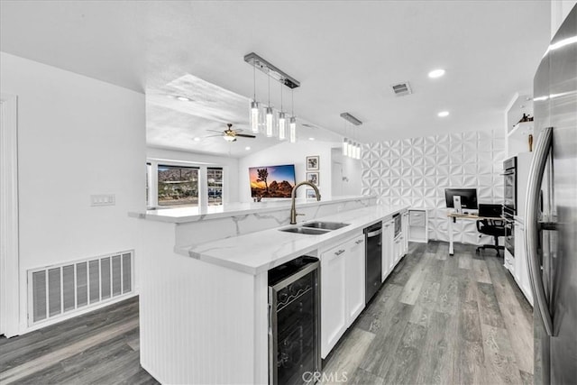 7068 Eucalyptus Ave Unit 29, Palms, CA 92277 - kitchen featuring beverage cooler, white cabinets, light stone countertops, ceiling fan, and open floor plan