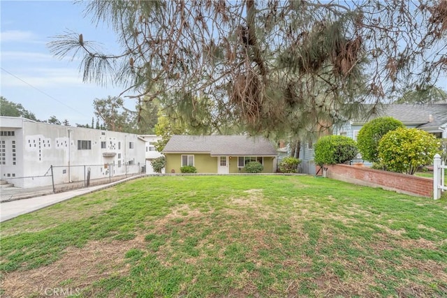 exterior space featuring a front lawn and fence