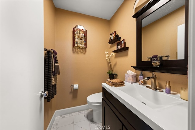 half bath featuring vanity, toilet, baseboards, and marble finish floor