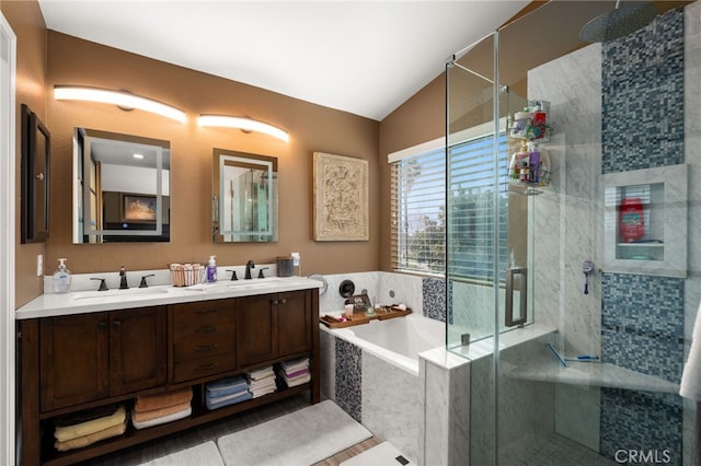 full bathroom with a sink, double vanity, a bath, and a shower stall