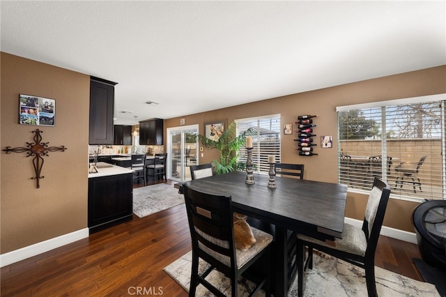 dining room featuring baseboards and dark wood-style flooring