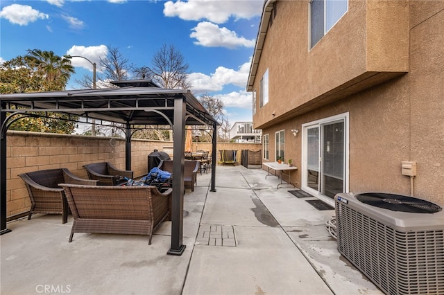 view of patio featuring a gazebo, fence, an outdoor living space, and central AC