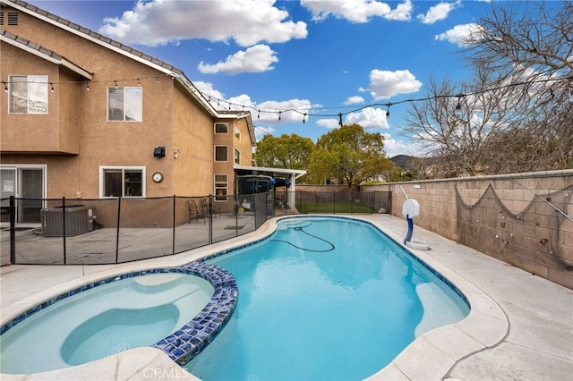 view of pool with central AC unit, a patio, a pool with connected hot tub, and a fenced backyard