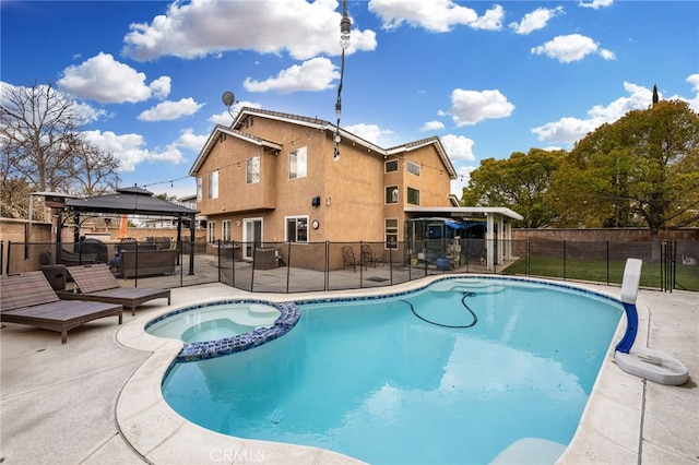 view of pool featuring a gazebo, a pool with connected hot tub, a patio, and fence