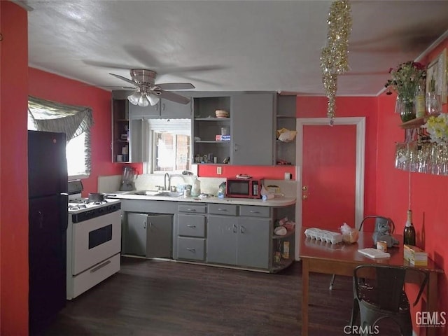 kitchen with a sink, gas range gas stove, a ceiling fan, gray cabinets, and open shelves