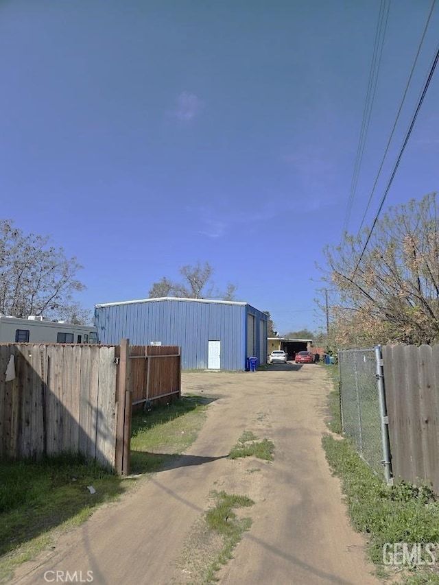 view of street featuring dirt driveway