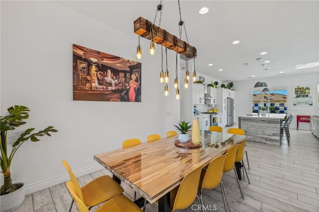 dining area featuring recessed lighting, light wood-style floors, and baseboards