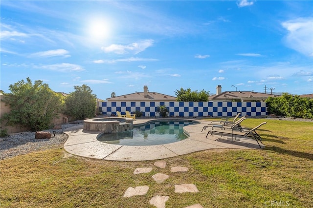 view of pool with a lawn, a pool with connected hot tub, and a patio