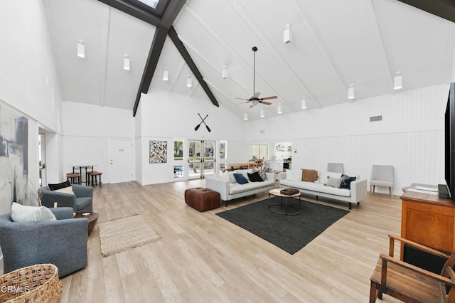 living room with visible vents, ceiling fan, beam ceiling, wood finished floors, and high vaulted ceiling