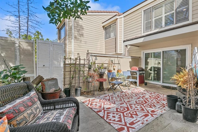 view of patio featuring area for grilling and fence