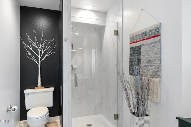 full bathroom featuring toilet and a marble finish shower