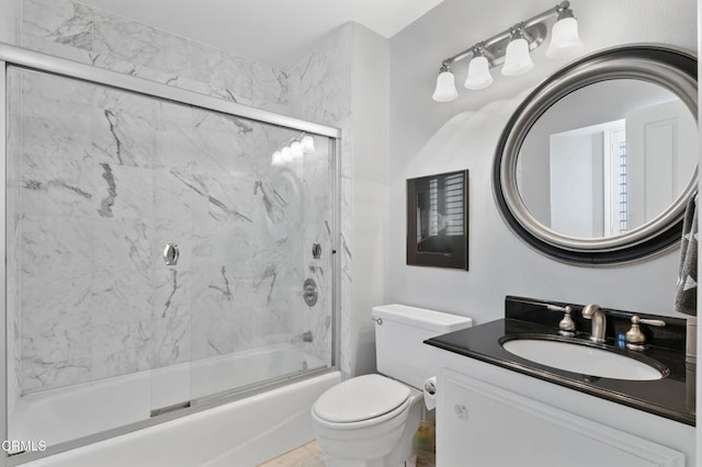 full bath featuring shower / bath combination with glass door, vanity, and toilet