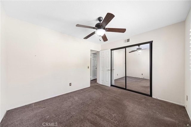 unfurnished bedroom featuring visible vents, carpet floors, a closet, and a ceiling fan