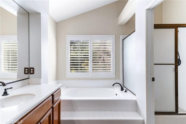 full bath featuring lofted ceiling, a bath, and vanity