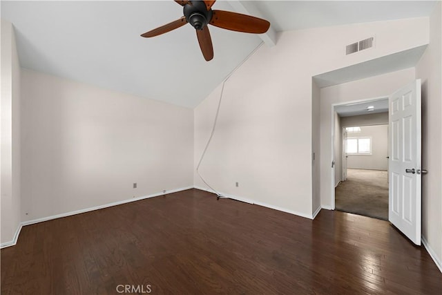 empty room with visible vents, lofted ceiling with beams, baseboards, and wood finished floors