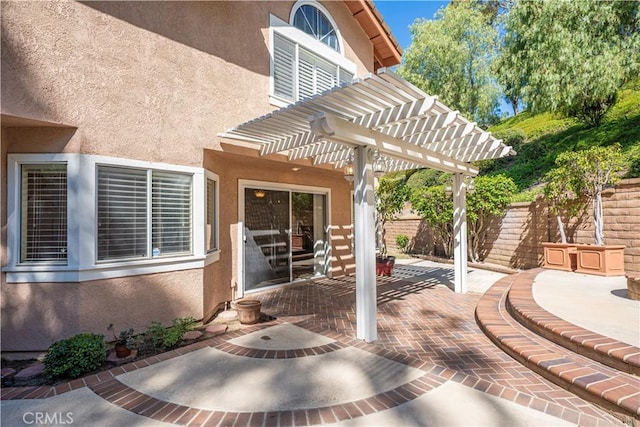 view of patio with a pergola and fence