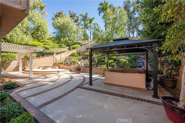 view of patio / terrace featuring a gazebo, a pergola, a hot tub, and fence