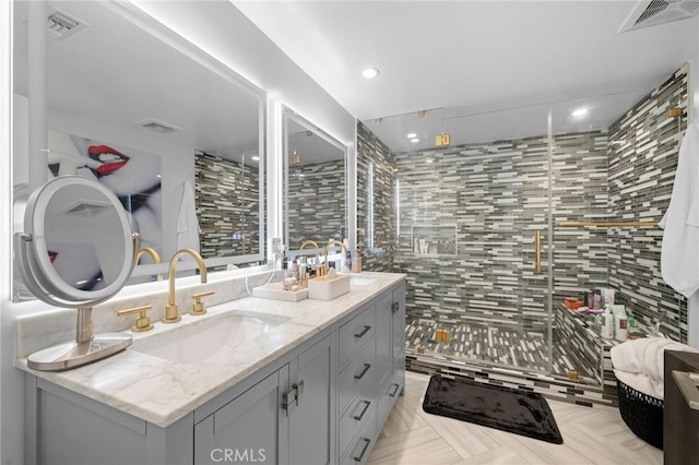 full bathroom featuring visible vents and a sink