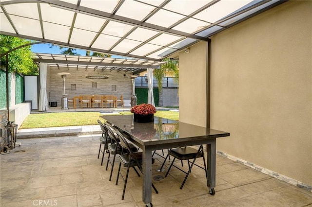 view of patio / terrace with outdoor dining area, fence, and a pergola