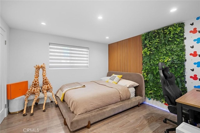 bedroom with recessed lighting and wood finished floors