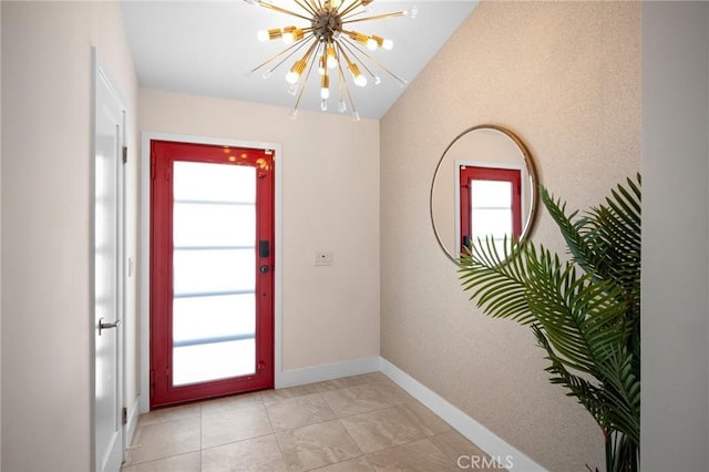 entryway with baseboards, plenty of natural light, a notable chandelier, and lofted ceiling