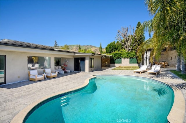 outdoor pool featuring a patio area