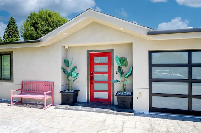 entrance to property with stucco siding