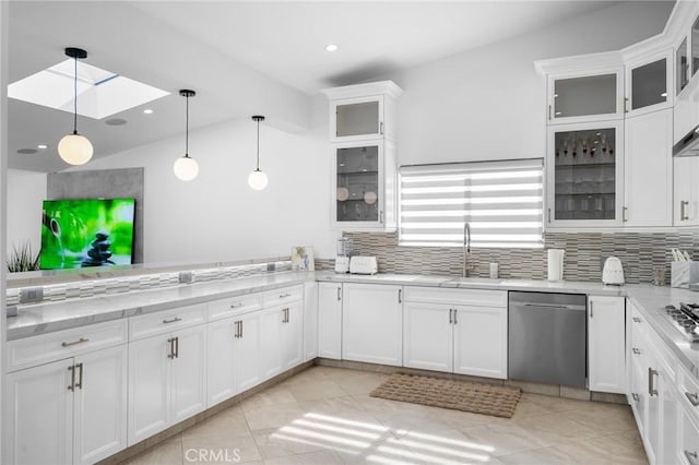 kitchen featuring tasteful backsplash, hanging light fixtures, dishwasher, and a sink