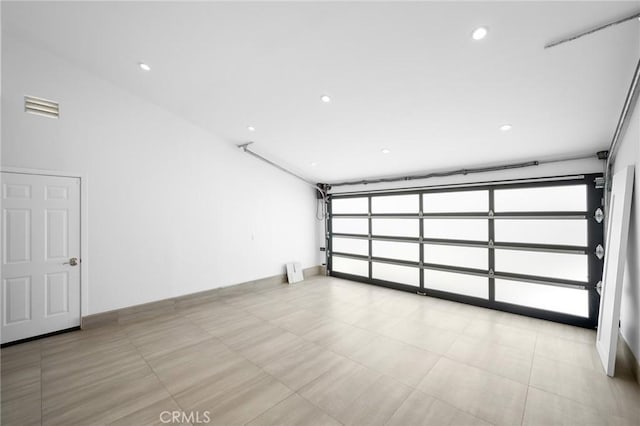 garage featuring visible vents, recessed lighting, and baseboards