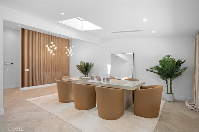 dining area with lofted ceiling with skylight, recessed lighting, and baseboards