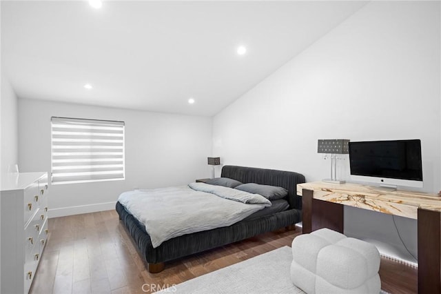 bedroom featuring recessed lighting, baseboards, lofted ceiling, and wood finished floors