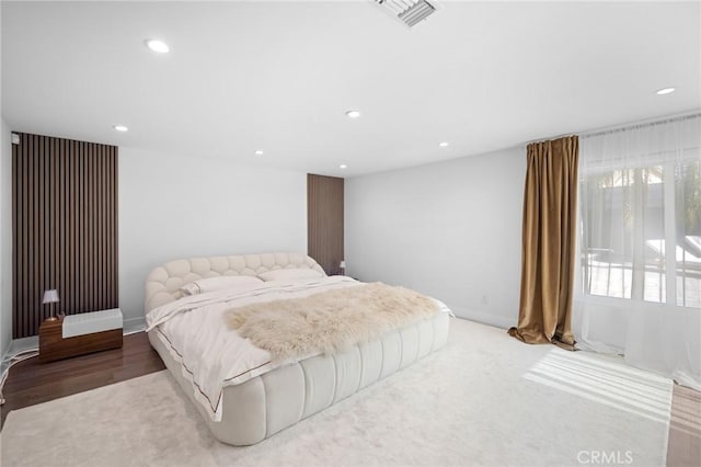 bedroom with visible vents, recessed lighting, baseboards, and wood finished floors