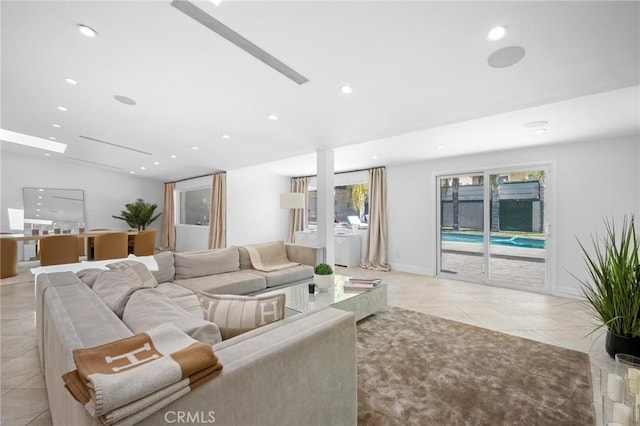 living room with light tile patterned floors, recessed lighting, and baseboards