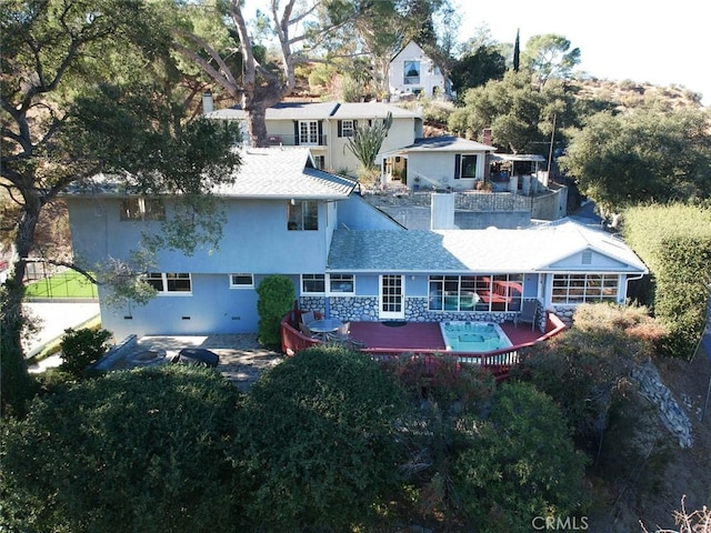 rear view of property featuring a shingled roof