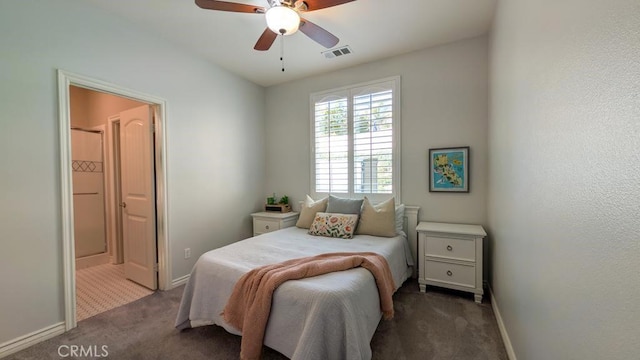 carpeted bedroom with a ceiling fan, baseboards, visible vents, and ensuite bathroom