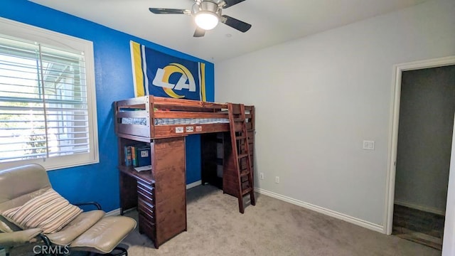 bedroom with a ceiling fan, baseboards, and carpet floors