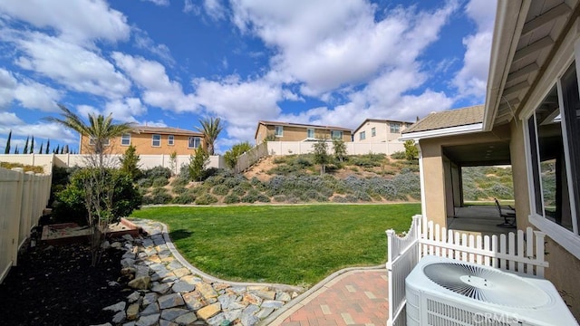 view of yard featuring a fenced backyard and central AC