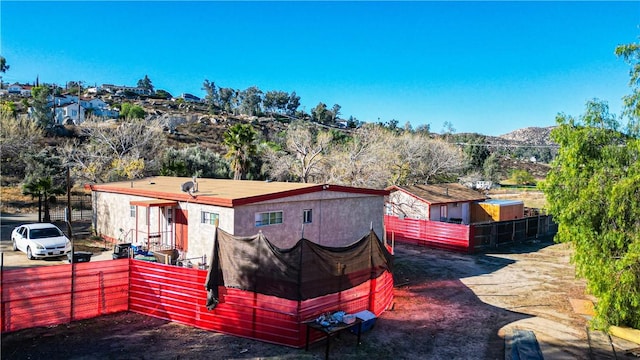 rear view of property featuring fence and a mountain view