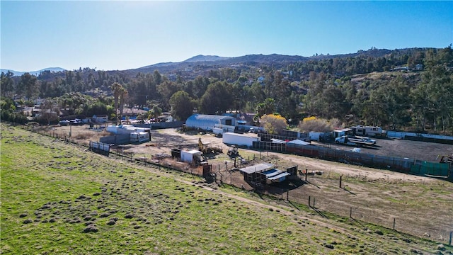 drone / aerial view featuring a mountain view and a view of trees