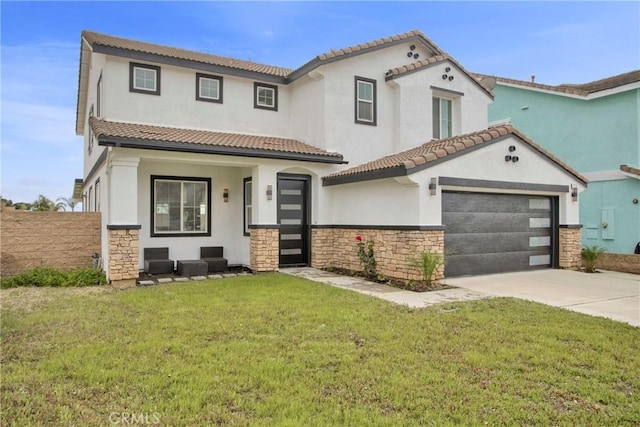 mediterranean / spanish-style home with a front lawn, a tile roof, stucco siding, stone siding, and driveway