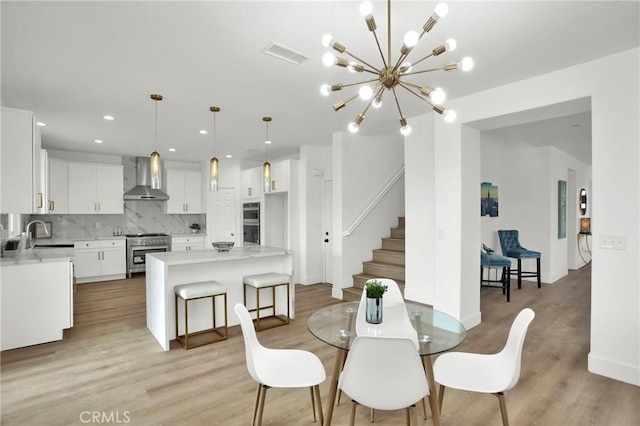 dining space with visible vents, recessed lighting, stairway, and light wood-type flooring